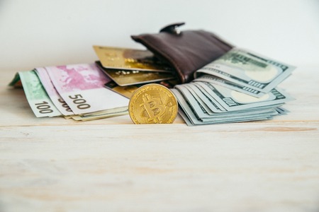 money euro dollars and bitcoin with wallet and bank cardsの写真素材
