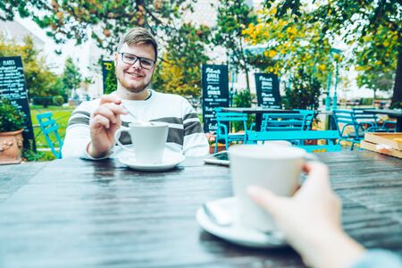 couple sitting in cafe outasideの写真素材