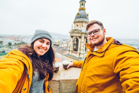 couple take a selfie with beautiful cityscape on backgroundの写真素材
