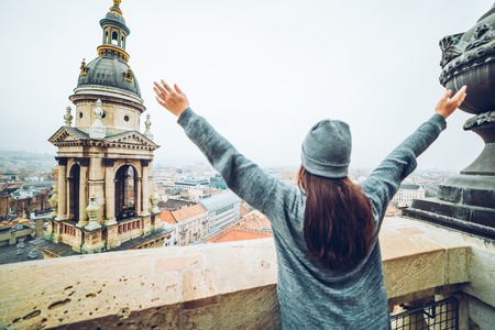 woman rise hand up with beautiful view at old european cityの写真素材