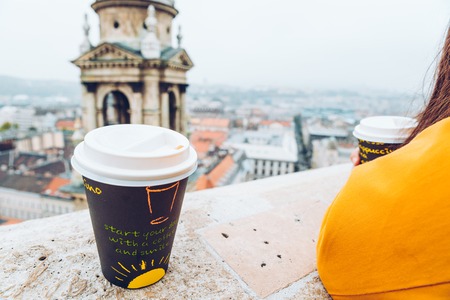 two cups of coffe panormaic view to old european city