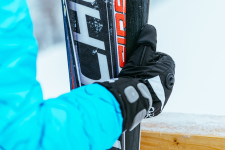 woman hand in gloves  hold ski close upの写真素材