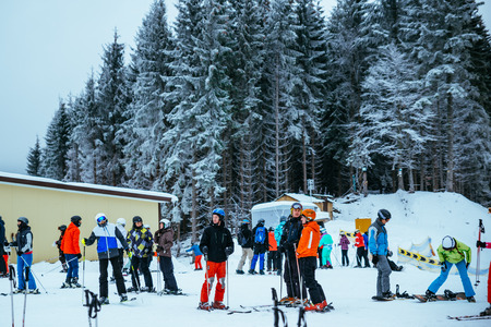 Ukraine, bukovel - December 17, 2017: people skiing and snowboarding at winter carpathian mountains