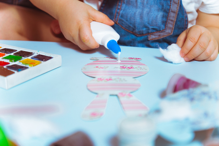 mother with kid making paper bunny hands close upの写真素材