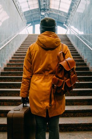 woman climb stairs with bags at railway station travel conceptの写真素材