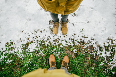 man stand in place where winter meet springの写真素材
