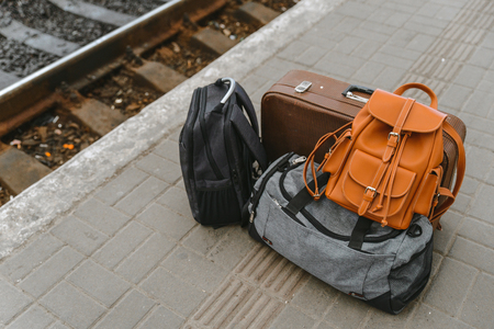 bags at railway station near railroad. travel conceptの写真素材