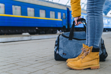 woman take bag at railway station. travel conceptの写真素材