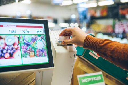 man weigh fruits on digital scales. shopping conceptの写真素材