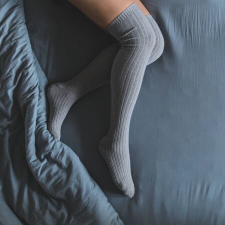 woman legs in stocking in bed. overhead viewの写真素材