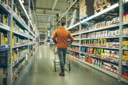 man walk between rows of store. shopping conceptの写真素材