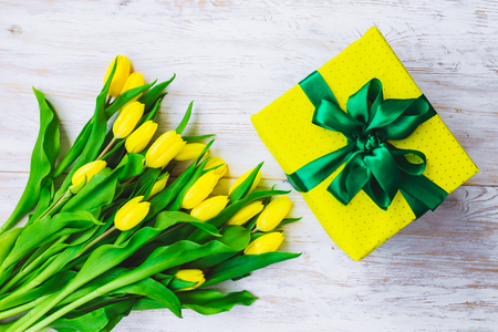 gift box with bouquet of yellow tulips. overhead viewの写真素材