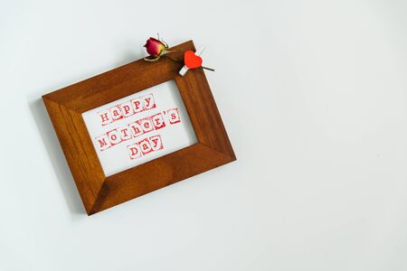 happy mothers day in wooden frame on white background. copy spaceの写真素材