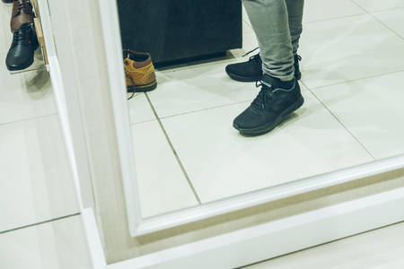 man seek new sneakers in store. shopping concept. shoes fashion buy shoppingの写真素材