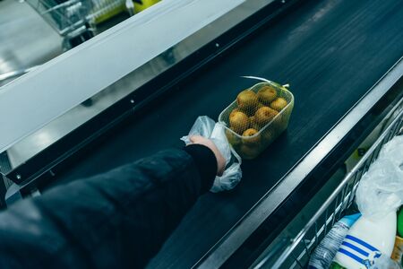 man put products on cash line in store. grocery shopping. first point of view.