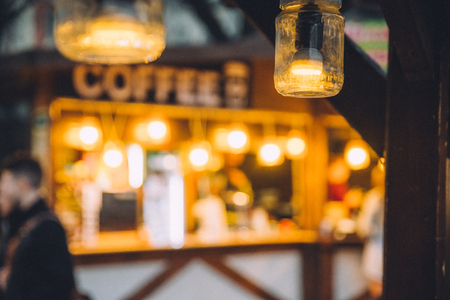 street food festival. evening lamp in outside cafe. blurred backgroundの写真素材