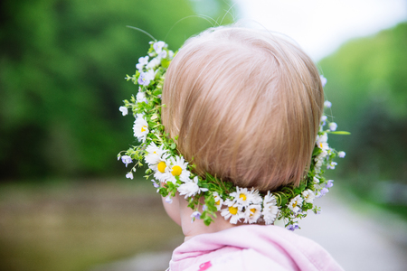 wreath on child forehead close up. chamomileの写真素材