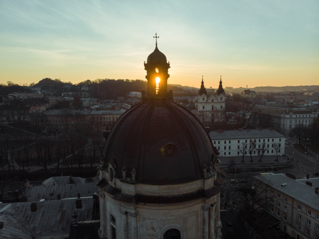 church dome with bell and christ in the top on sunrise.の写真素材