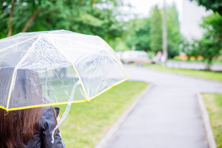 woman with transparent umbrella. rainy weather.の写真素材