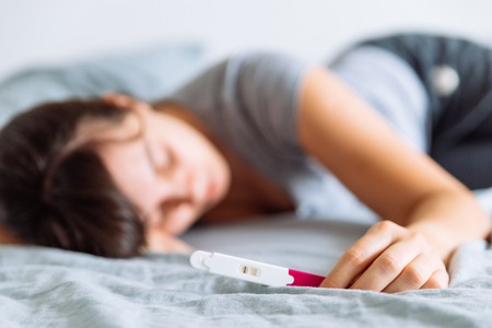 negative pregnancy test. sad woman on backgroundの写真素材