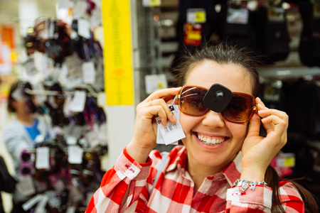 woman choosing sunglasses in mall. shopping conceptの写真素材