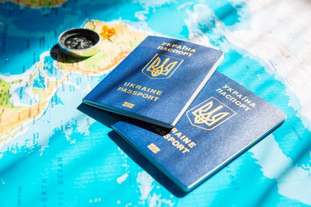 travel concept. two passports with compass on world map