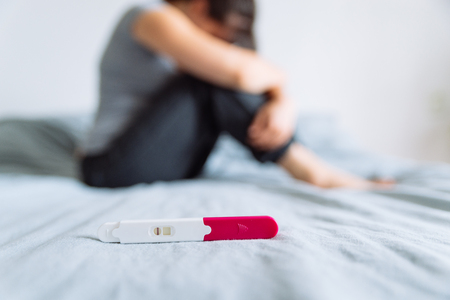 negative pregnancy test. sad woman on backgroundの写真素材