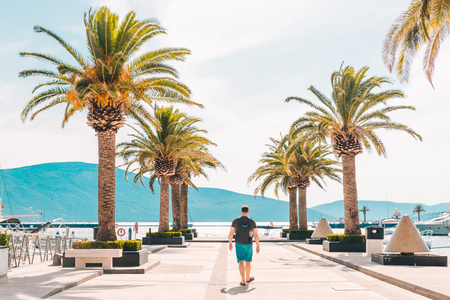 man walking by pier in summer day. summer time conceptの写真素材