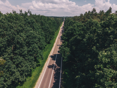 aerial view of straight highway. sunny day. car travel conceptの写真素材