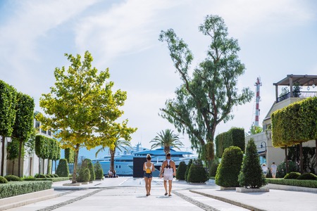 couple walking by harbor , yacht on background. summer timeの写真素材