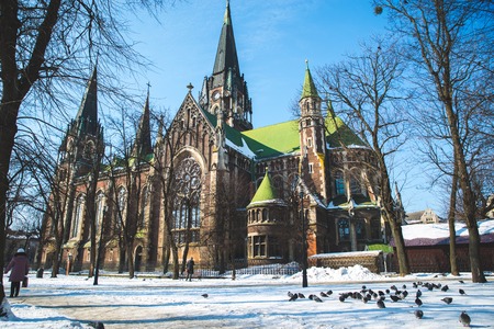 old gothic church in winter day with blue skyの写真素材
