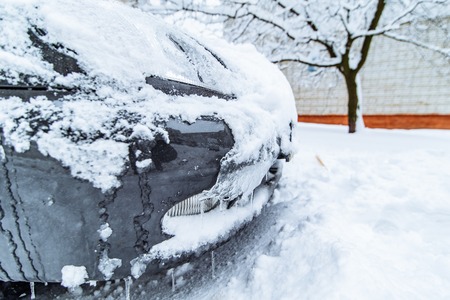 car in ice and snow parked in yard. winter timeの写真素材