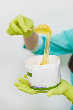 woman interfere sugar for sugaring. beautician salonの写真素材