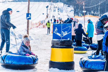 LVIV, UKRAINE - March 3, 2018: people in line to ride from snow hill. snow tubing. winter activityのeditorial素材
