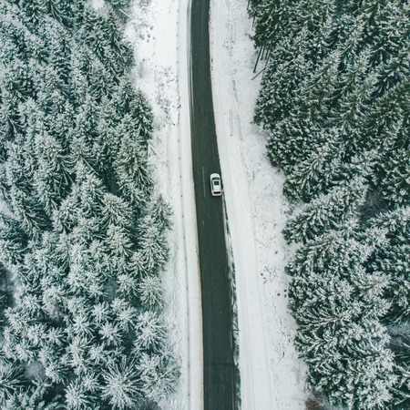 white suv overhead view road trip frozen highway in snowed winter time.