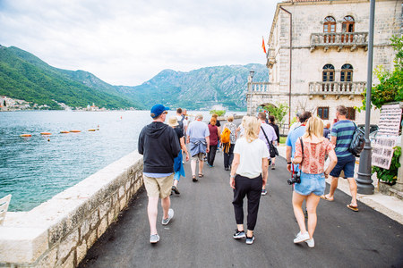 PERAST, MONTENEGRO - July 17, 2018: group of tourists walk by Perast town near adriatic sea. summer travel conceptのeditorial素材