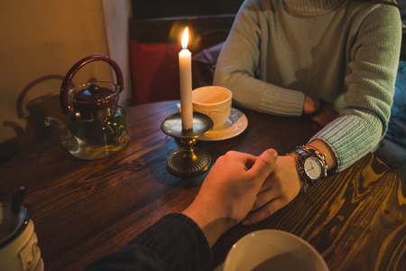 couple holding hands in cafe. romantic date. lifestyleの写真素材