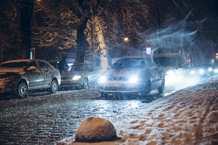 road city traffic in winter snowstorm night. collapseの写真素材