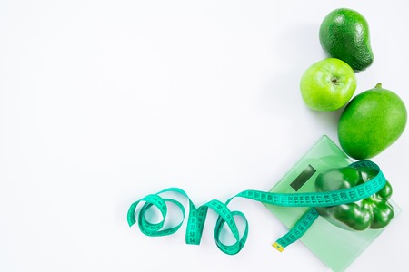 healthy food concept. overhead view of fruits and vegetables on weight on white background. copy spaceの写真素材