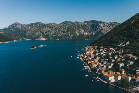 aerial view of seaside with boats and building roofs. summer time