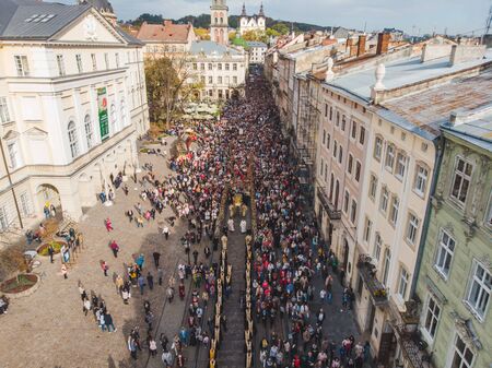 LVIV, UKRAINE - October 7, 2018: aerial view religious procession at city streets. nuns and monks