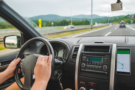 person driving car by speedway. navigation on the phone. travel conceptの写真素材
