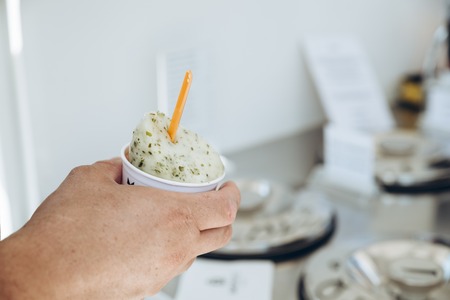 man hand holds ice cream cup. summer time concept