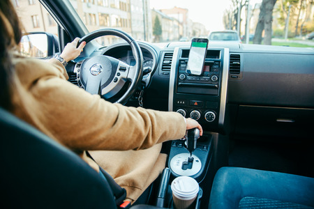young woman hand on gear shift stick in car. road trip