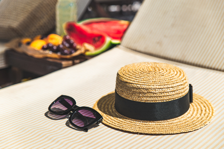 beach stuff bag towel blanket on sun longer. fruits on the table. summer vacation. sea beachの写真素材
