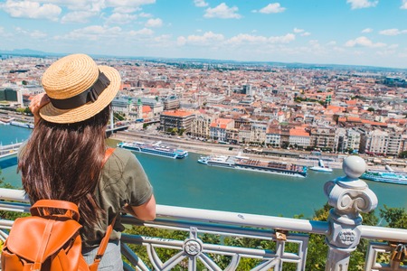 young stylish woman looking at panoramic view of budapest city. summer travel conceptの写真素材