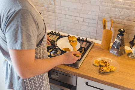 man cooking pancakes at the kitchen. copy spaceの写真素材