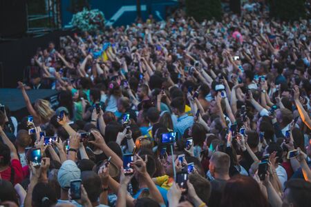 LVIV, UKRAINE - June 18, 2019: people shooting on phones rock concert near sceneのeditorial素材