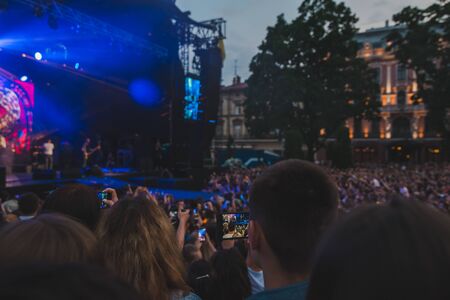 LVIV, UKRAINE - June 18, 2019: wide angel crowd before rock stage at city square. copy spaceのeditorial素材