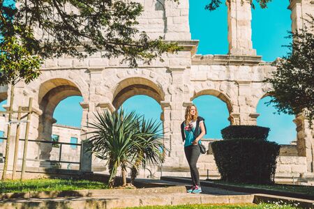 PULA, CROATIA - May 17, 2019: woman posing in front of old roman arena in pula city. summer travel conceptのeditorial素材